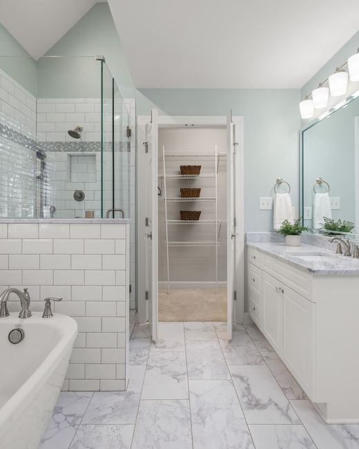 Bathroom remodel idea: white subway tile, a freestanding tub, and a marble-top vanity