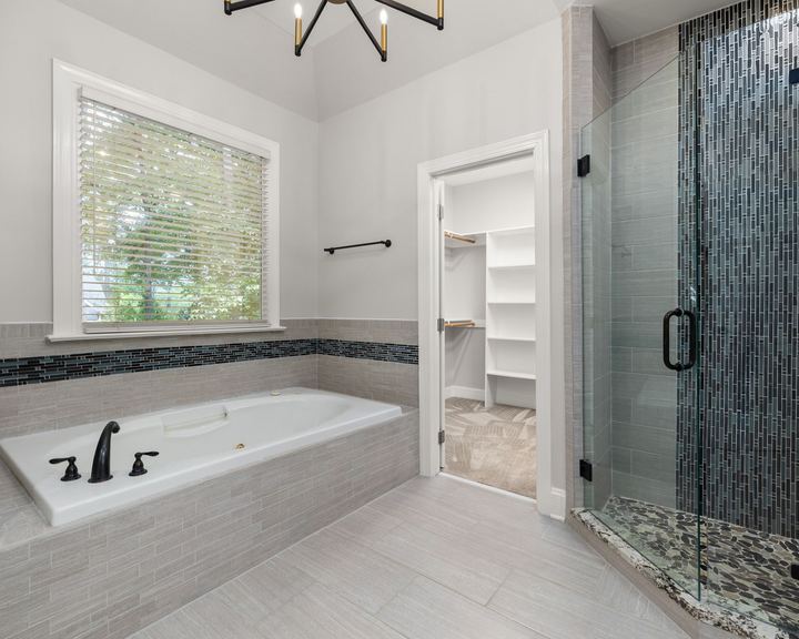 Bathroom remodeling idea: bright bathroom with a frameless glass shower and a tiled soaking tub