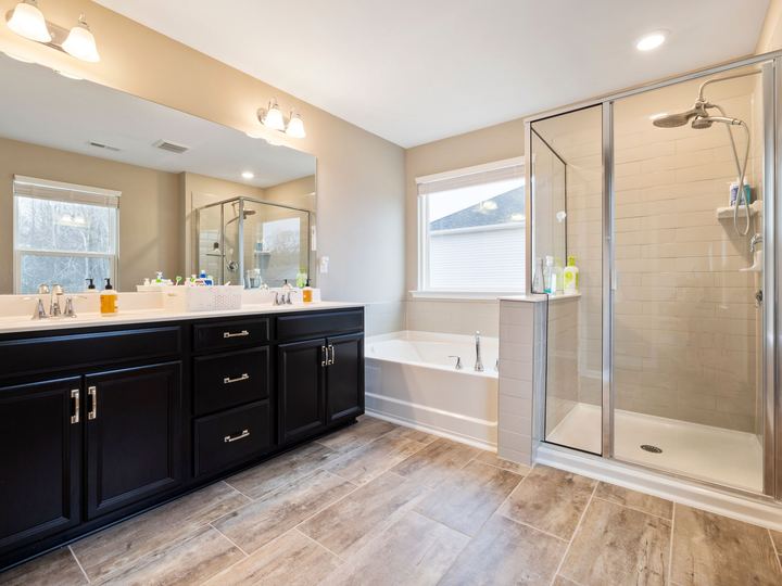 Master bathroom remodel idea with a double vanity, soaking tub, and glass walk-in shower